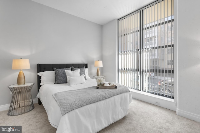 carpeted bedroom with baseboards