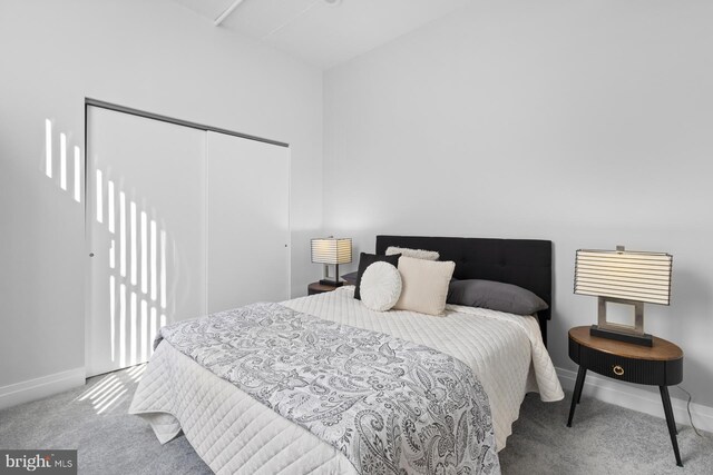 bedroom with a closet, baseboards, and carpet floors