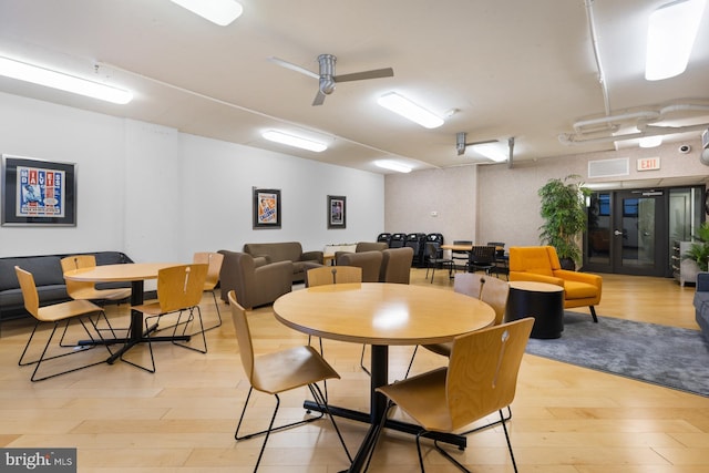 dining room featuring visible vents, a ceiling fan, and light wood-style floors