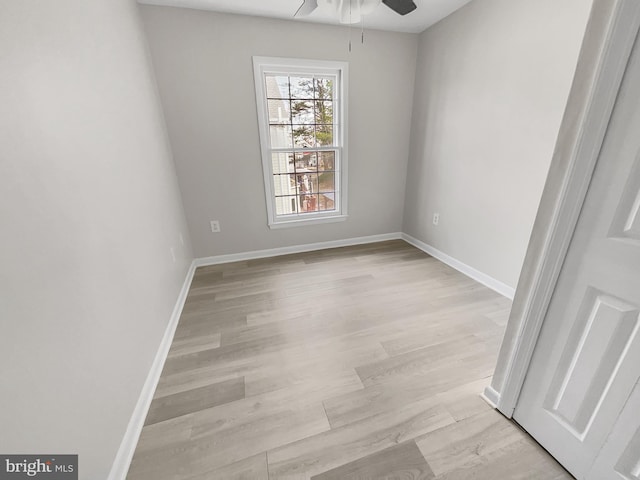 empty room with baseboards, light wood-style floors, and ceiling fan