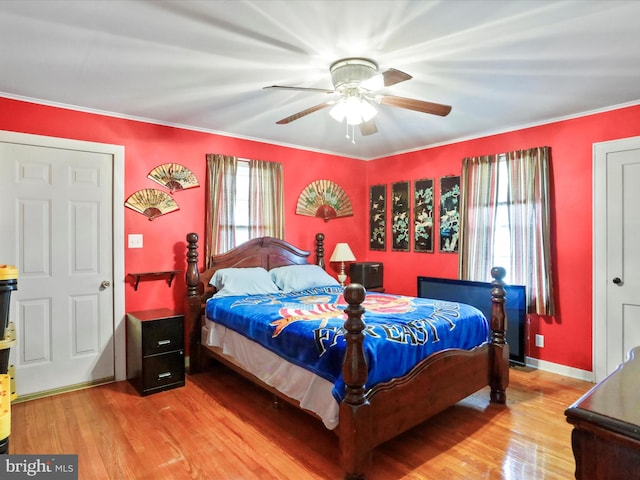 bedroom featuring ceiling fan, baseboards, wood finished floors, and ornamental molding