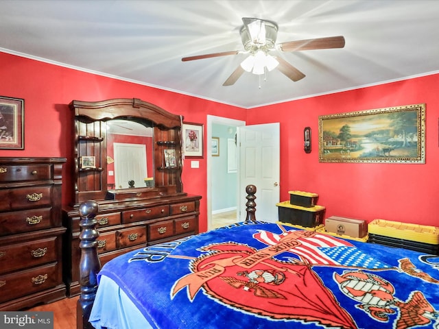 bedroom with ceiling fan, wood finished floors, and crown molding