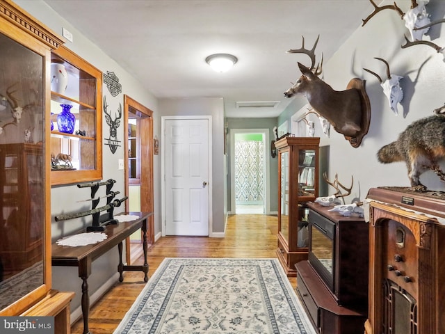 interior space with baseboards and light wood finished floors