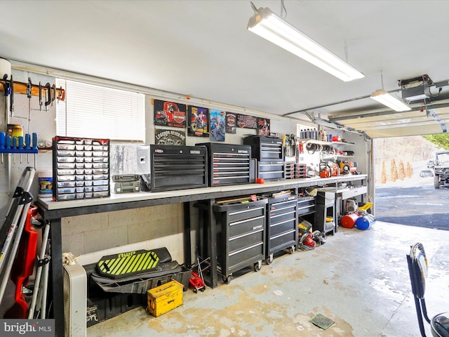 garage featuring a workshop area and a garage door opener