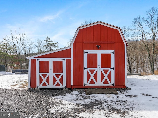 snow covered structure with an outdoor structure