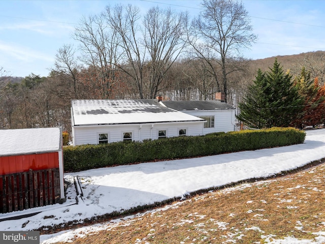 exterior space featuring a storage unit and an outbuilding