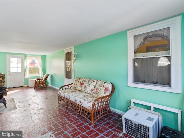 living area with brick floor and baseboards