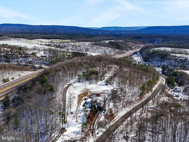 snowy aerial view featuring a mountain view