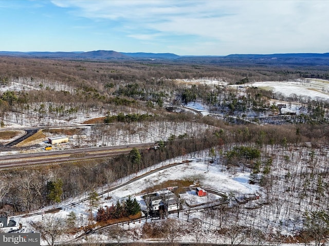 snowy aerial view with a mountain view