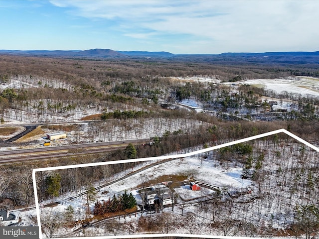 snowy aerial view featuring a mountain view