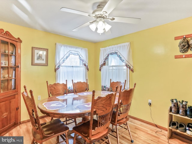 dining room featuring baseboards, light wood-type flooring, and ceiling fan