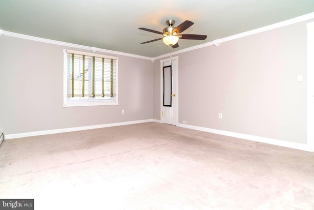 spare room featuring baseboards, carpet, a ceiling fan, and ornamental molding