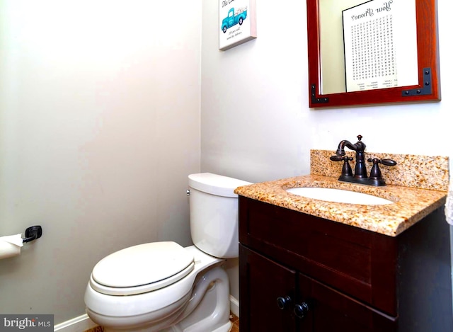 bathroom featuring toilet and vanity