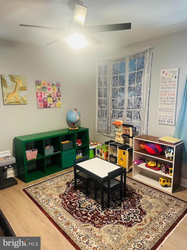 recreation room with wood finished floors and ceiling fan