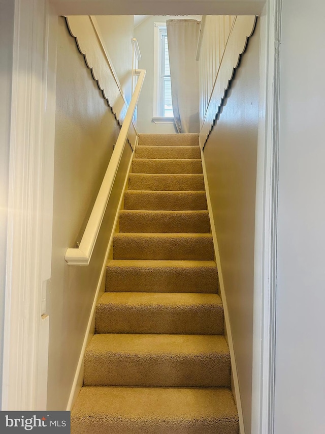 stairs featuring baseboards