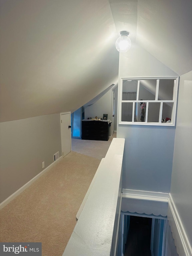 bonus room with baseboards, visible vents, carpet floors, and lofted ceiling