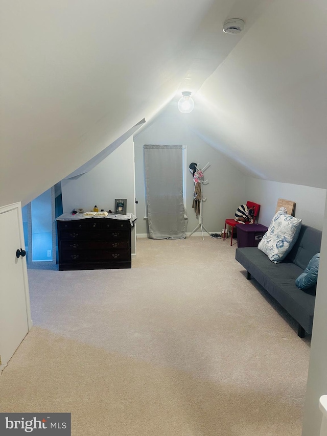 interior space featuring carpet floors and vaulted ceiling