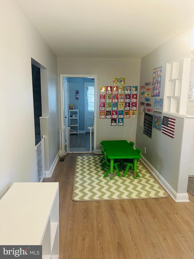 rec room featuring baseboards and wood finished floors