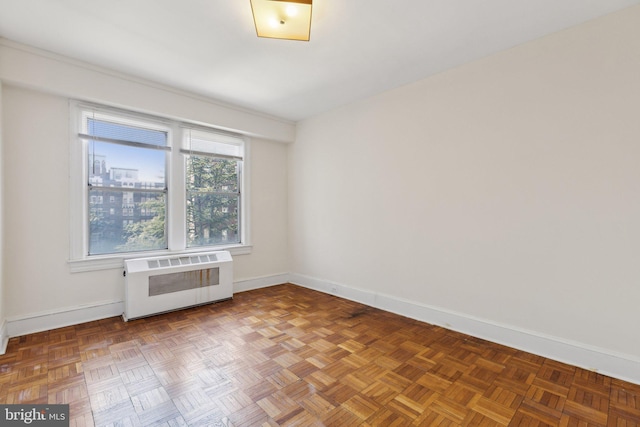 empty room featuring radiator heating unit and baseboards