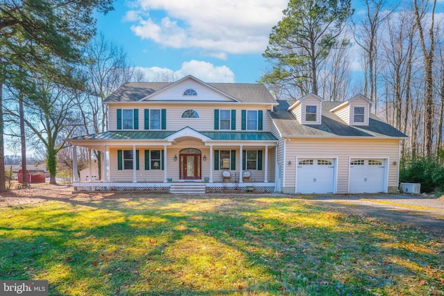 view of front of property with a front yard, roof with shingles, covered porch, a garage, and driveway