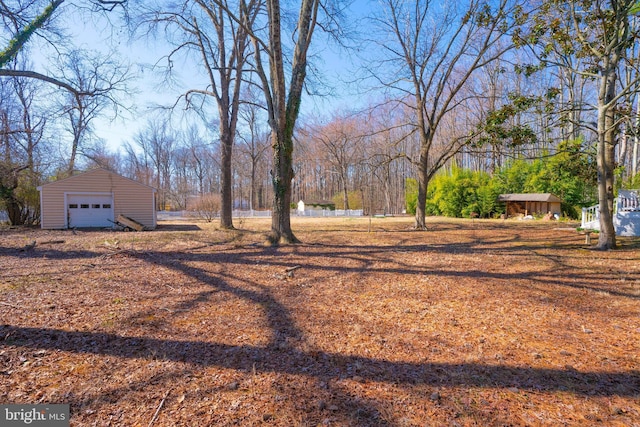 view of yard featuring an outdoor structure and a detached garage