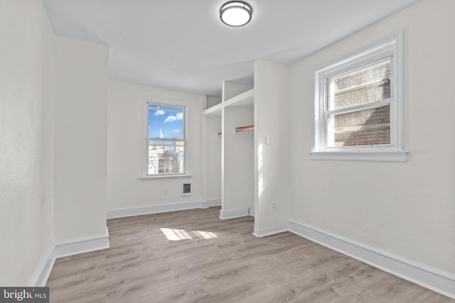 interior space with visible vents, baseboards, and light wood finished floors