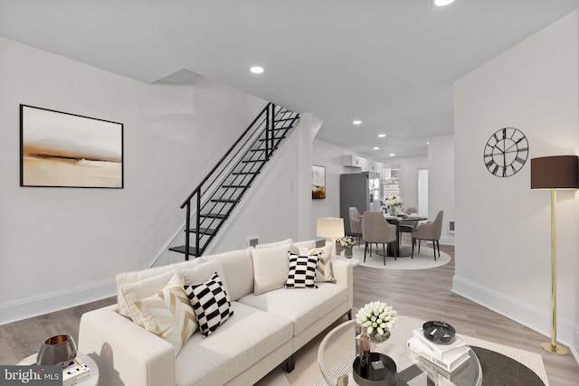 living room featuring stairway, recessed lighting, and wood finished floors