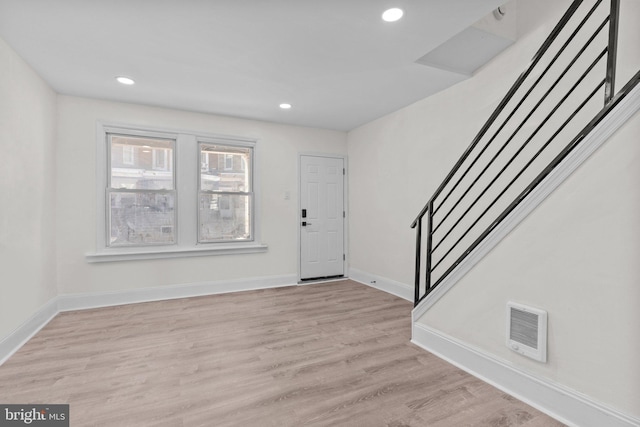 entrance foyer with stairway, recessed lighting, light wood-style flooring, and baseboards