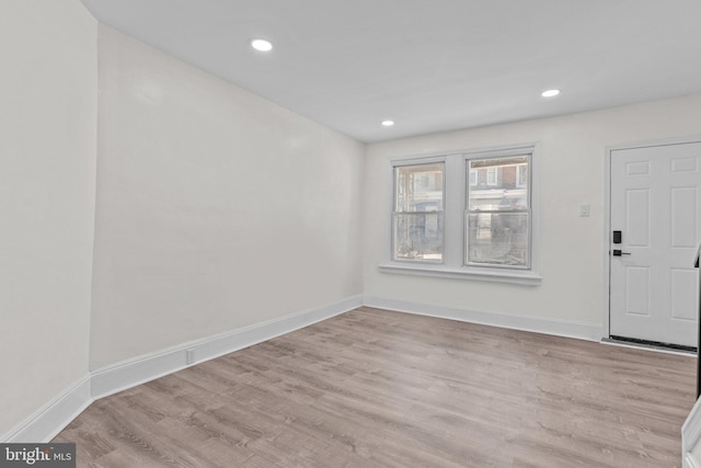 entryway with recessed lighting, wood finished floors, and baseboards