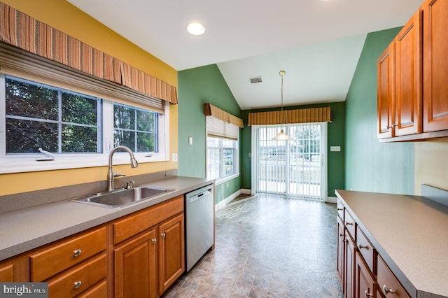 kitchen with visible vents, lofted ceiling, a sink, pendant lighting, and dishwasher