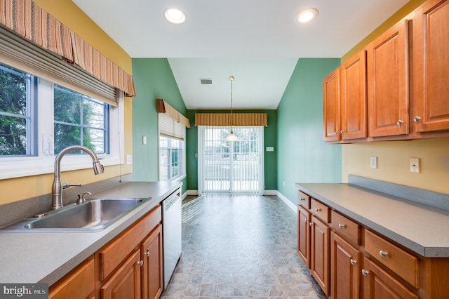 kitchen with visible vents, baseboards, dishwasher, vaulted ceiling, and a sink