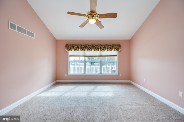 carpeted empty room with visible vents, baseboards, high vaulted ceiling, and a ceiling fan