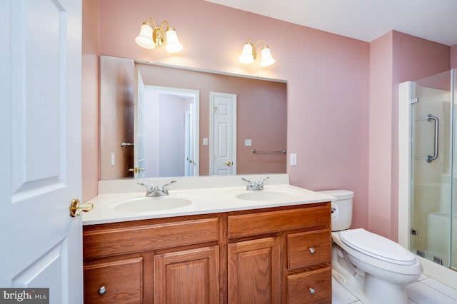 bathroom featuring a shower stall, toilet, double vanity, and a sink