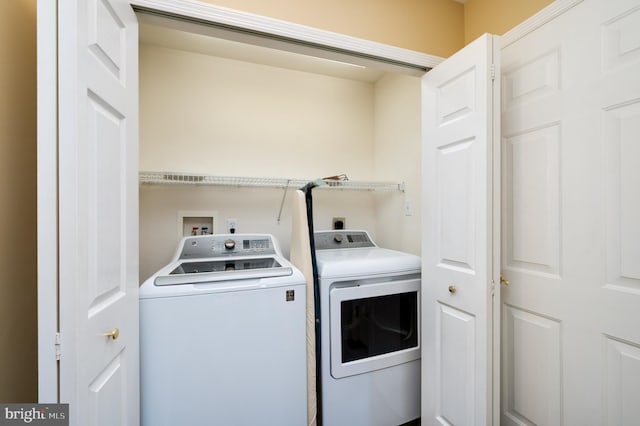 clothes washing area featuring washer and dryer and laundry area