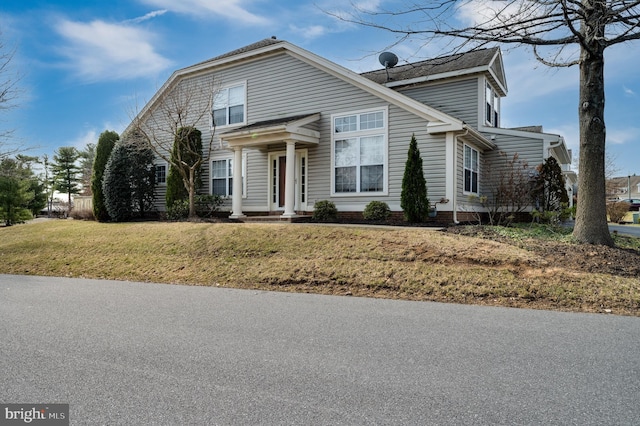 traditional-style home featuring a front yard