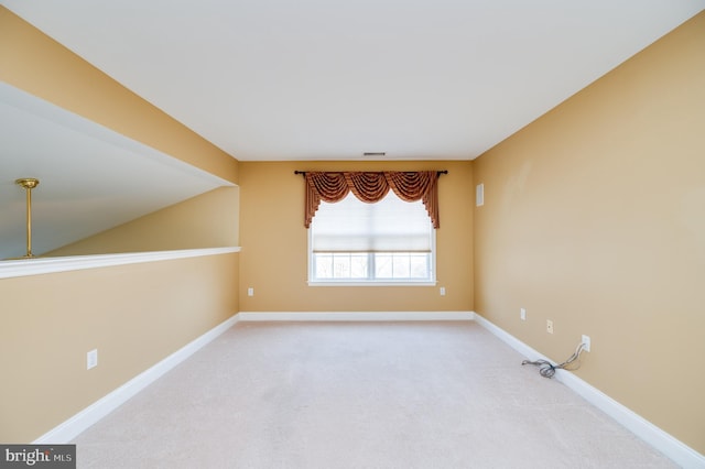 carpeted empty room featuring visible vents and baseboards