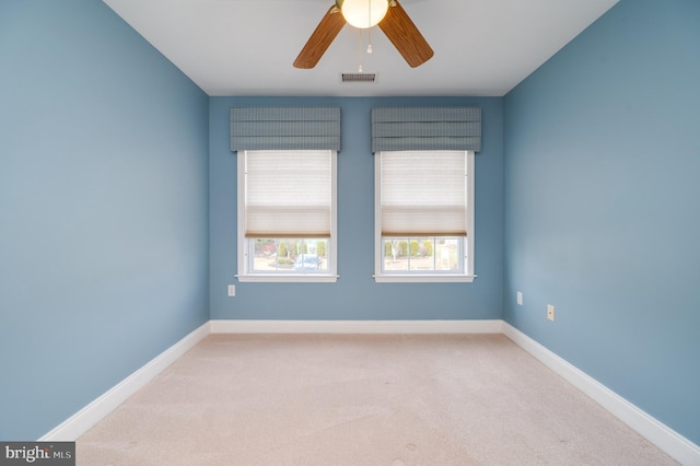 spare room featuring visible vents, baseboards, carpet, and ceiling fan