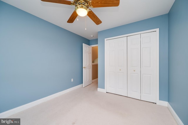 unfurnished bedroom featuring a closet, carpet flooring, a ceiling fan, and baseboards