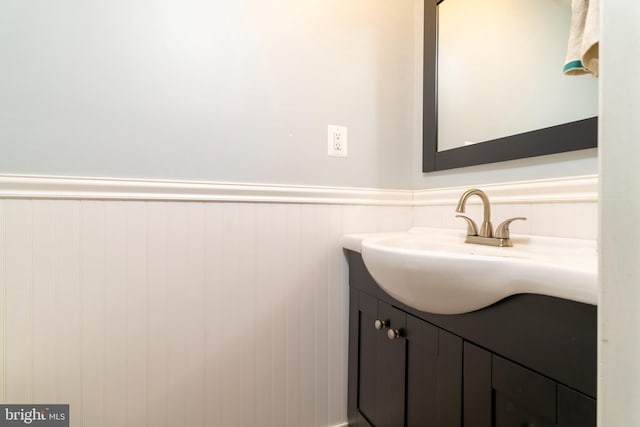 bathroom featuring a wainscoted wall and vanity