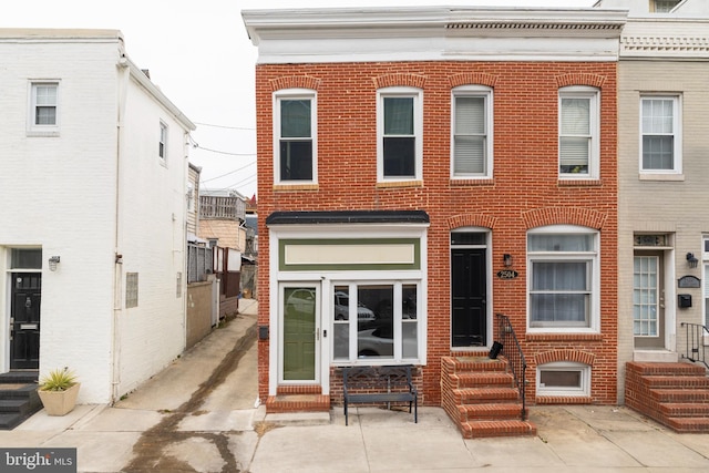 multi unit property featuring entry steps and brick siding