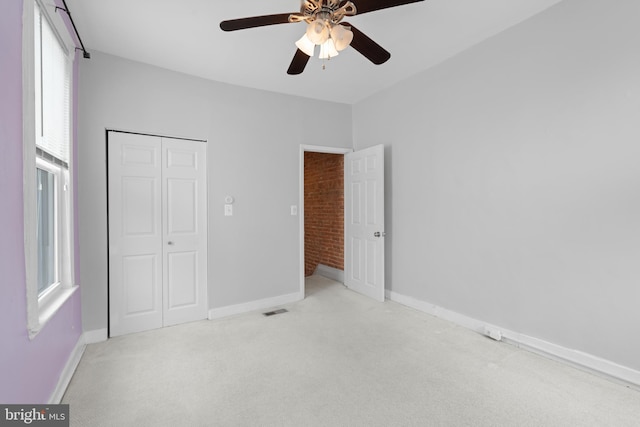 unfurnished bedroom with visible vents, ceiling fan, baseboards, carpet flooring, and a closet