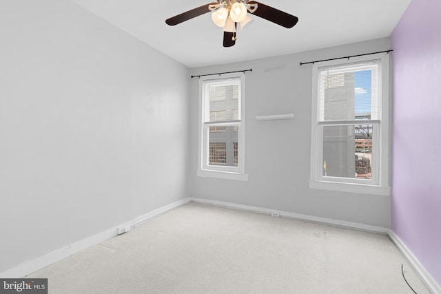 carpeted empty room with baseboards and ceiling fan