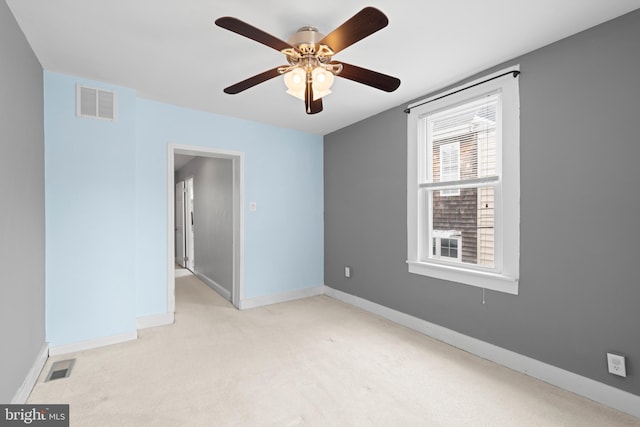 unfurnished room with visible vents, carpet floors, and baseboards