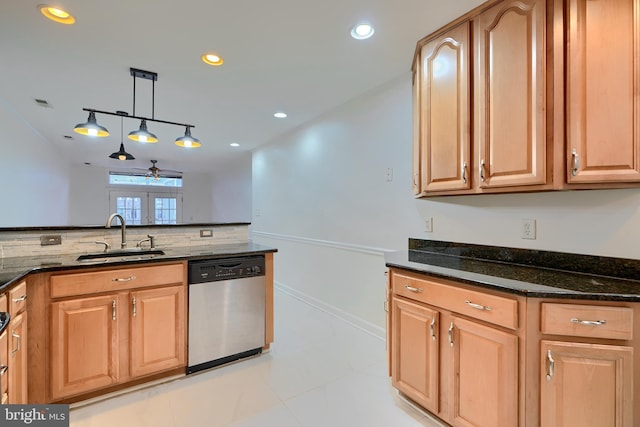 kitchen with pendant lighting, a sink, dark stone countertops, recessed lighting, and dishwasher