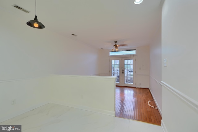 interior space with french doors, visible vents, marble finish floor, and baseboards