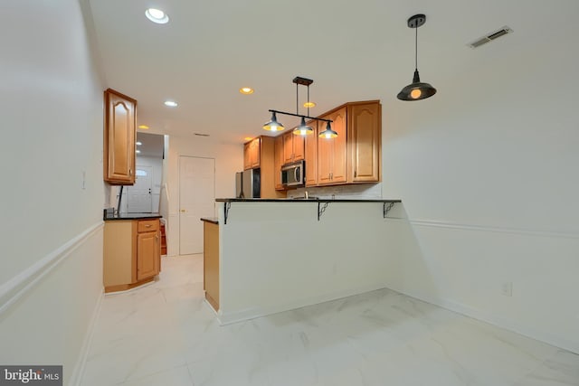 kitchen featuring dark countertops, stainless steel microwave, visible vents, recessed lighting, and marble finish floor