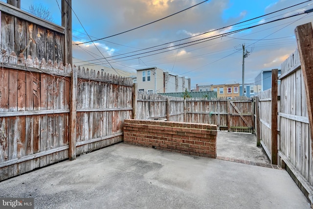 view of patio featuring a fenced backyard and a gate