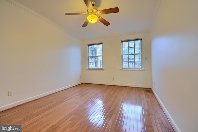 unfurnished room featuring visible vents, baseboards, light wood finished floors, ceiling fan, and ornamental molding