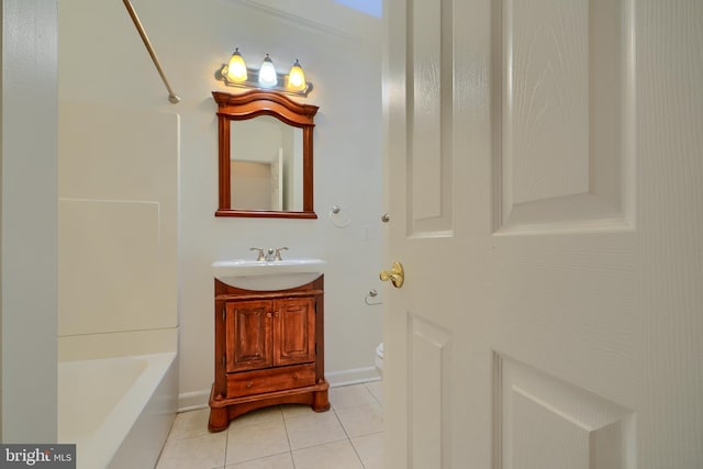 full bath with tile patterned floors, toilet, vanity, baseboards, and shower / bathtub combination