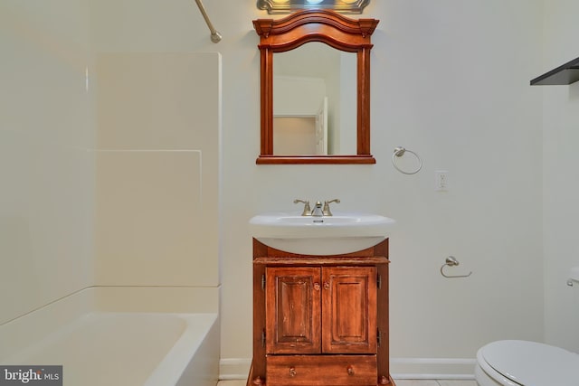 full bath featuring vanity, toilet, washtub / shower combination, and baseboards